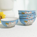 Cinq bols bleus Maneki Neko présentés sur une table.